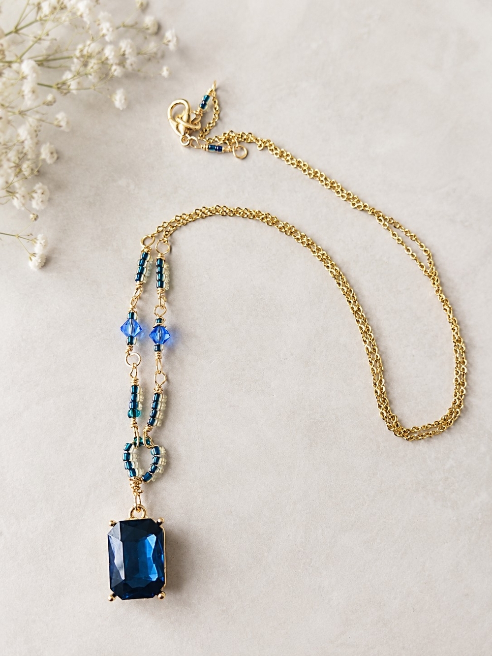 Gold Chain Necklace with Deep Blue Pendant and Beaded Accents
